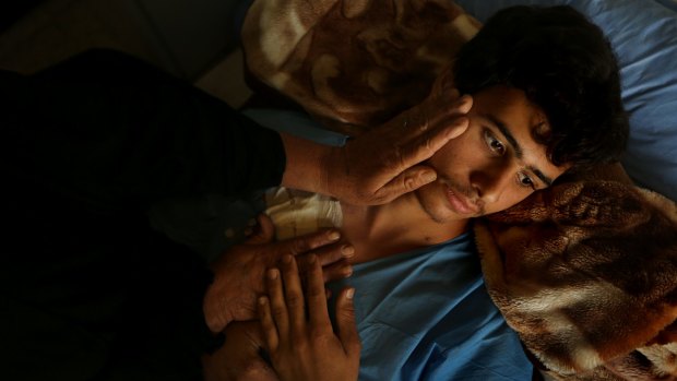 Ismail Abdul Hassan, 17, a volunteer fighter, recovers in hospital in Baghdad after battling Islamic State militants.