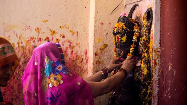  A woman offers Garland to the Goddess Kaali on the last day of Hindu festival Navrati in Kali devi temple . Navratri comes twice in a Year in which nine form of Goddess are worship . It is celebrated mainly in North India .