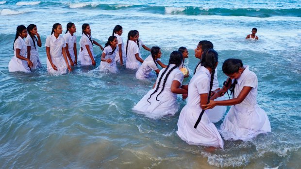 Schoolgirls from Kandy play in the sea.