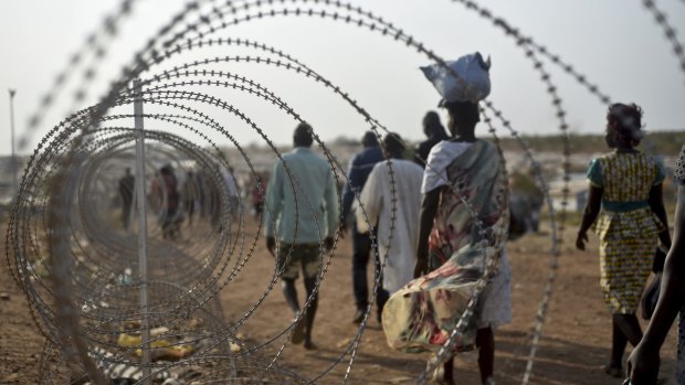 Displaced people walk at the United Nations base in the capital Juba, South Sudan. 