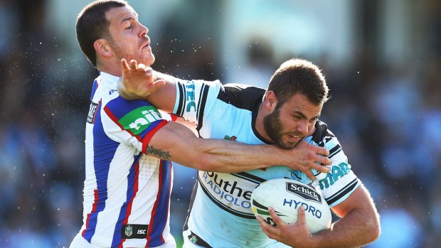 Don't argue: Sharks forward Wade Graham fends away the Newcastle Knights defence at Southern Cross Group Stadium last weekend.