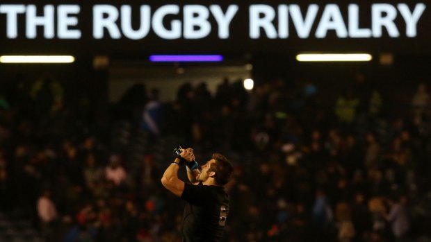 Narrow escape: Richie McCaw leaves the pitch after his team's victory over Scotland.