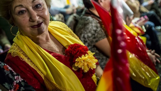 An attendee wearing the colors of the Spanish national flag looks on ahead of a speech by Mariano Rajoy.