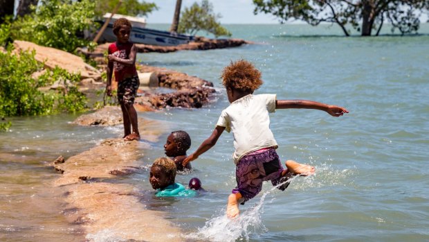 Children on Saibai island swim in the tides.