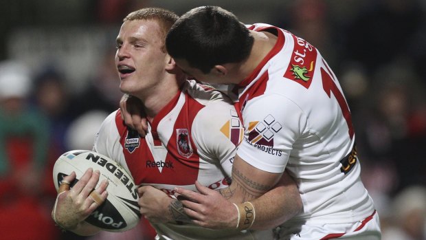 Red and white rookie: Alex McKinnon celebrates after scoring a try during his stint with St George Illawarra.