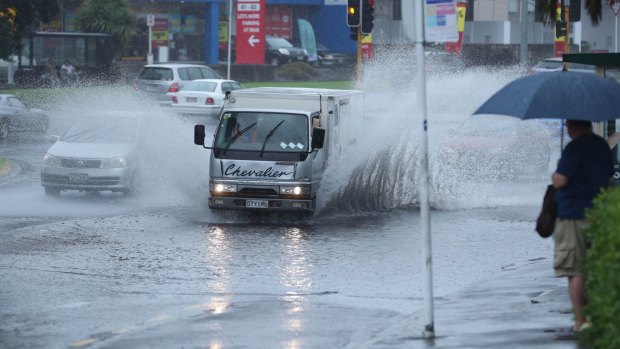 Heavy rainfall across Auckland is flooding roads.
