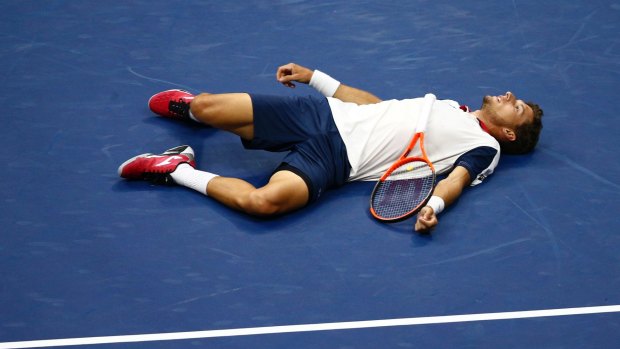 Pablo Carreno Busta, of Spain, lays on the court after missing a shot against Kevin Anderson. 