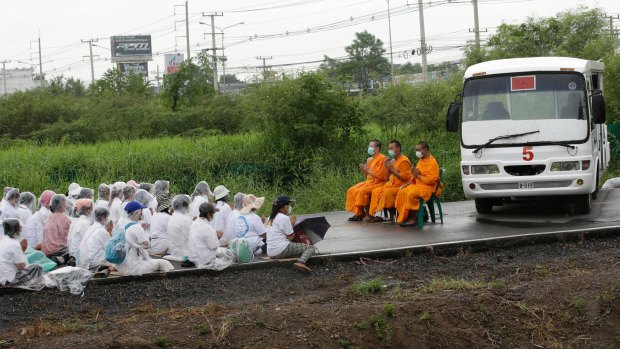 Monks and worshippers block the road outside the Dhammakaya Temple, north of Bangkok, last year.