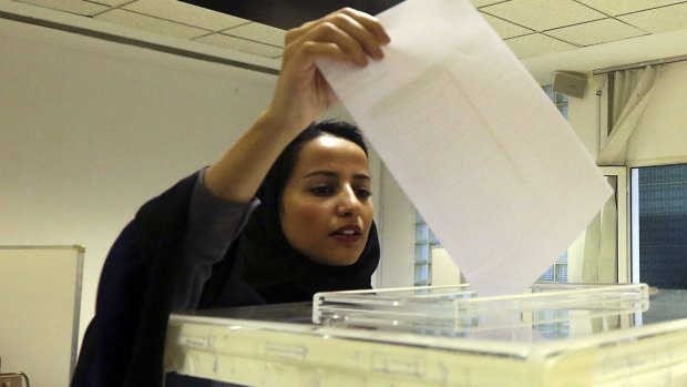 A Saudi woman casts her ballot at a polling centre during municipal elections in Riyadh, Saudi Arabia.