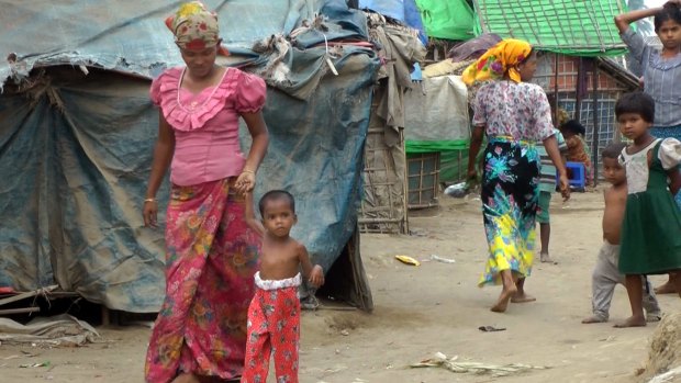 Four-year-old Rosmaida Bibi walks with the help of her mother  at the Dar Paing camp for Rohngyas in Rakhine State.