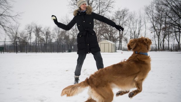 Rachel Crooks plays with her dog Carlow in a park in Tiffin, Ohio.  
