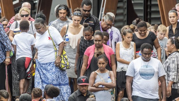 Cairns residents leave Cairns Convention Centre after attending a memorial service for eight children.
