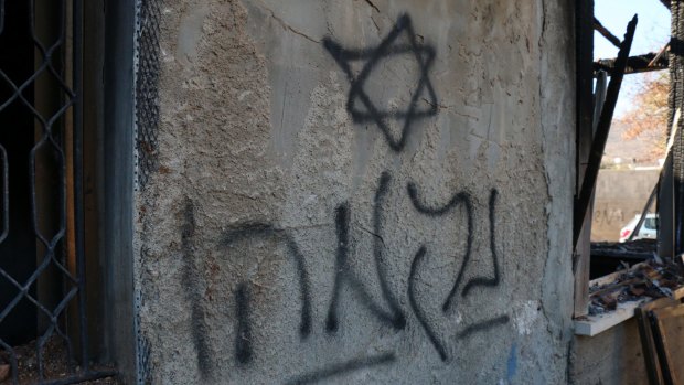 Hebrew graffiti - "Revenge" - sprayed on the wall of the Dawabshe family home.