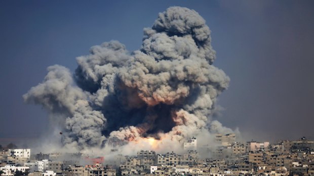 The explosion of an Israeli strike rises over Gaza City in July 2014.