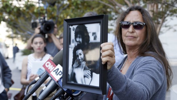 Janet Wolfe holds a photo of her brother Randy Wolfe, better known as Randy California, a member of the band Spirit outside US federal court on Thursday in LA. 