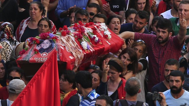Mourners carry the coffin of Duygu Tuna, one of the victims of the explosion on Monday in the town of Suruc, Turkey.