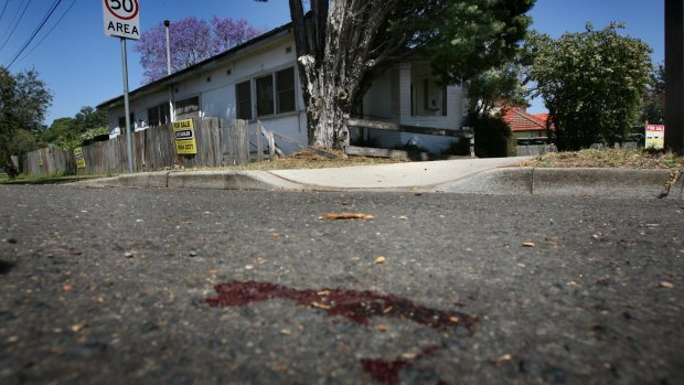Blood stained the road after the van's theft.