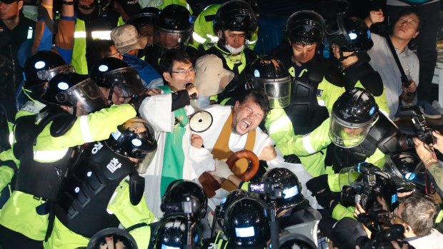 Residents and members of civic and religious groups battle riot police trying to break up their protest against the further deployment of Thaad in Seongju, South Korea.