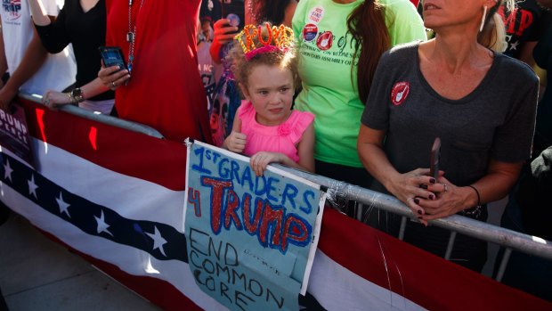 Six-year-old Amelia Good waits for Donald Trump's arrival in Orlando.