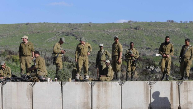 Israeli soldiers stand near the border with Lebanon after the latest exchange of fire.