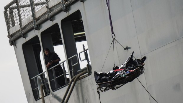 Rescuers recover a dead body from the Spanish ship 'Cantabria' in Salerno, Italy, last week.