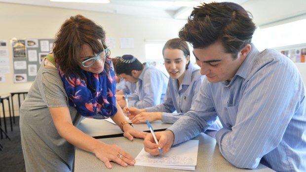 Leibler Yavnel college head of senior school English Rachel Kafka with year 12 students using pens and paper. 