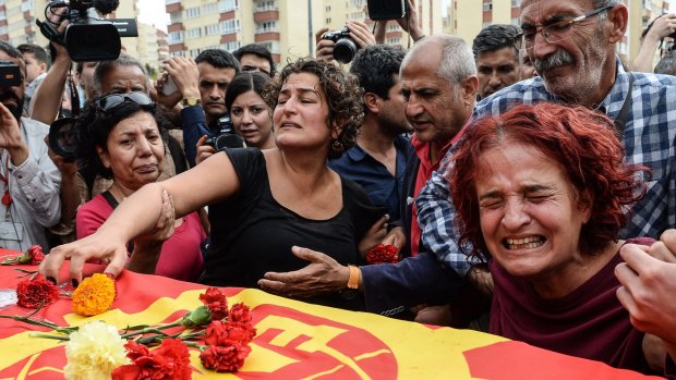 Family members of Korkmaz Tedik, a victim of the October 10 attack, mourn in Ankara.