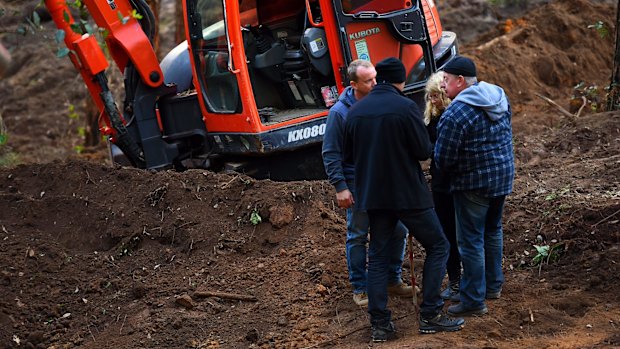 The Levesons and detectives at the site.