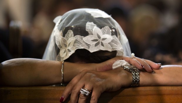 A Coptic Christian grieves during prayers remembering the victims of Thursday's crash at al-Boutrossiya Church in Cairo on Sunday.