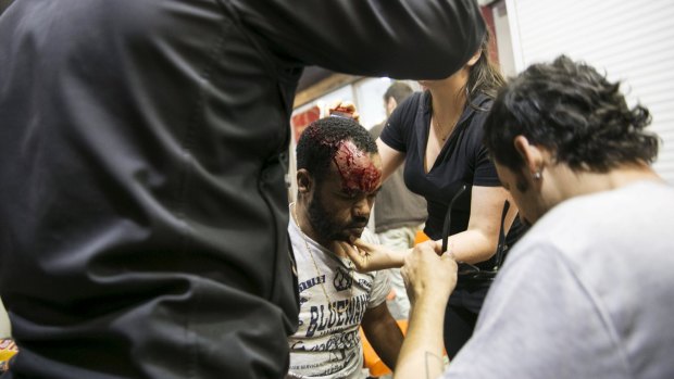 An Israeli Jew of Ethiopian origin is treated for an injury incurred during a demonstration in Tel Aviv on Sunday.
