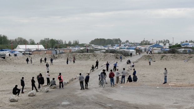 Refugees and migrants from Afghanistan use land where hundreds of tents and shelters were demolished at The Jungle in Calais, France.