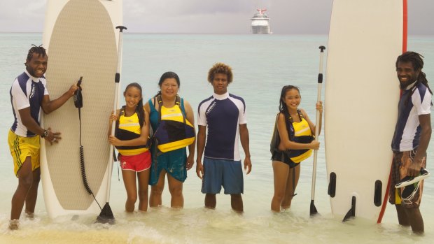 Carnival Spirit guests paddleboarding at Mystery Island.