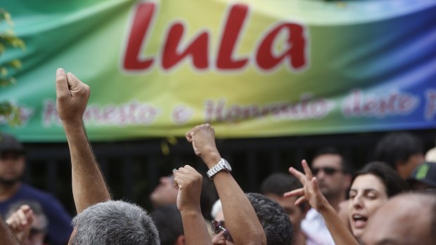 Supporters of Brazil's former president, Luiz Inacio Lula da Silva, gather outside his residence building, in Sao Bernardo do Campo, on Saturday.