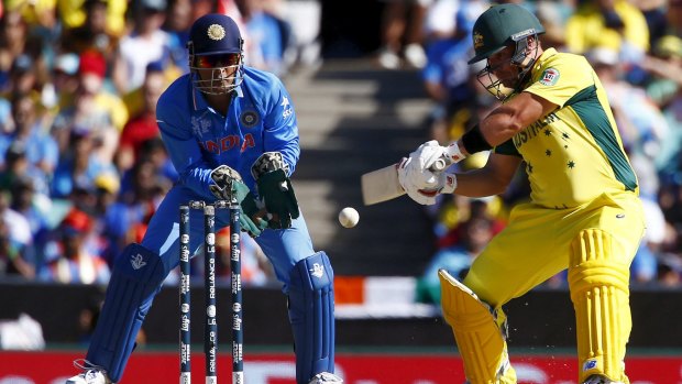 Cutting stroke: Australian batsman Aaron Finch plays a shot as India's captain MS Dhoni watches on.