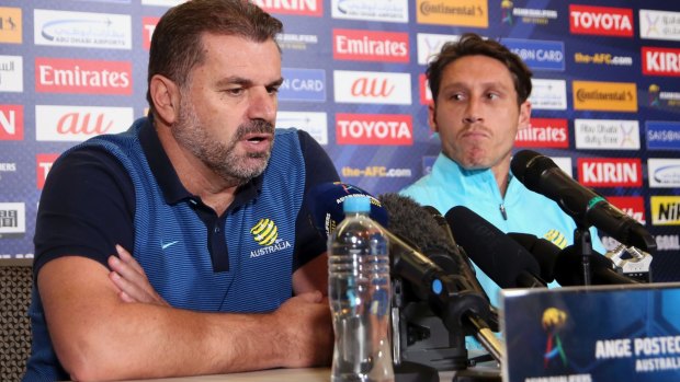 Australia's soccer head coach Ange Postecoglou, left, and player Mark Milligan discuss their pending Soccer World Cup qualifying match against Syria in Sydney on Tuesday.