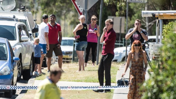 Local residents look on as police respond to an incident on Regent St in Riverstone.