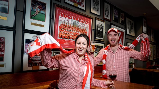 The Rising Sun Hotel in South Melbourne is gearing up for a big night on Saturday. Manager Mal Wakefield with fellow Swans supporter Amanda Parkinson.