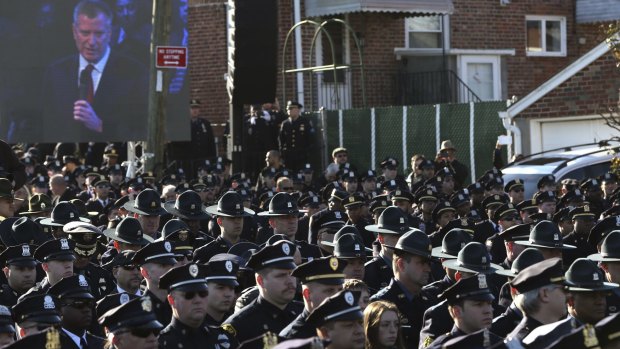 Police officers turned their backs on New York City Mayor Bill de Blasio during the funeral of Rafael Ramos on December 27.