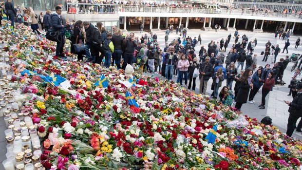 People leave flowers on the steps at Sergels Torg following Friday's attack in central Stockholm, Sweden.