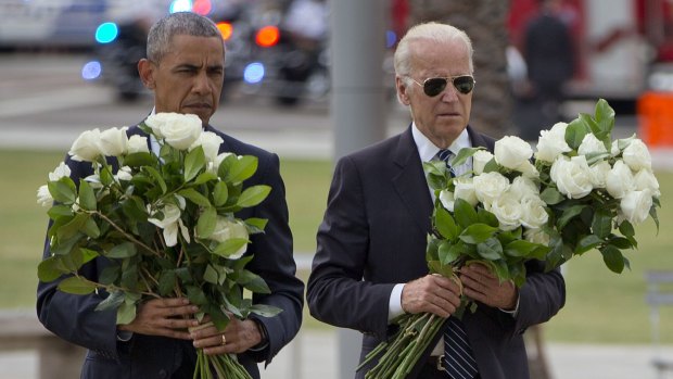 President Barack Obama and Vice-President Joe Biden carry bouquets of 49 white roses at a memorial for the Pulse victims.