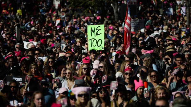 Protesters gather at the Grand Park for a Women's March against sexual violence and the policies of the Trump administration Saturday.