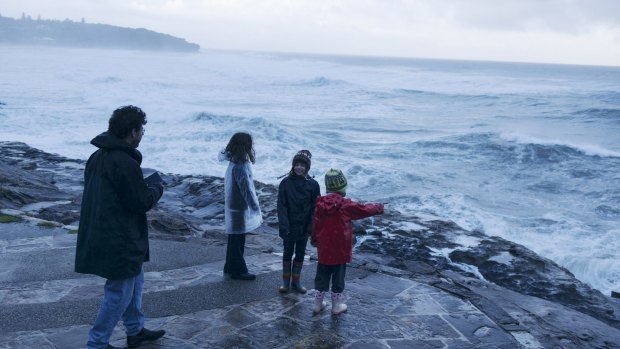 Sydneysiders at Curl Curl emerge to observe the last of the huge ocean swell.