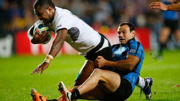 Kini Murimurivalu of Fiji holds off a tackle to score his side's sixth try.