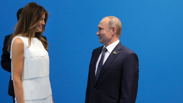 Russian President Vladimir Putin greets US President Donald Trump's wife Melania, prior to talks with Trump.