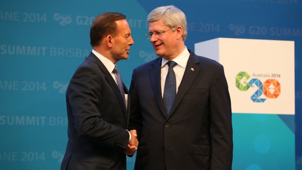 Shared concerns: Canadian Prime Minister Stephen Harper shakes Tony Abbott's hand in Brisbane last month. 