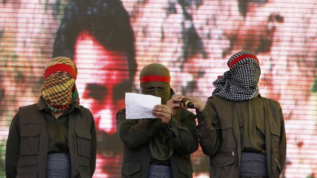 Masked supporters of jailed Kurdish rebel leader Abdullah Ocalan read out the PKK's ceasefire statement at a Newroz (new year) celebration in Diyarbakir, south-east Turkey, in 2013. The recent Turkish air strikes have effectively destroyed the ceasefire.