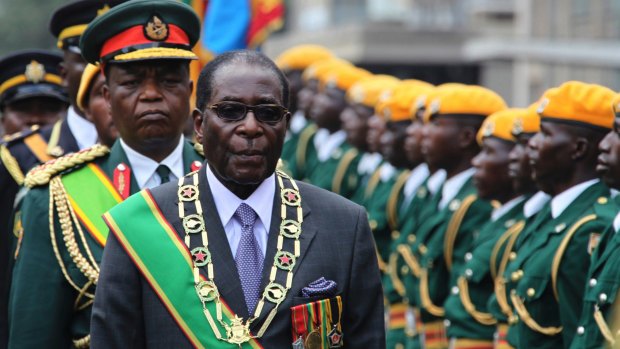 Robert Mugabe inspects a guard of honour.