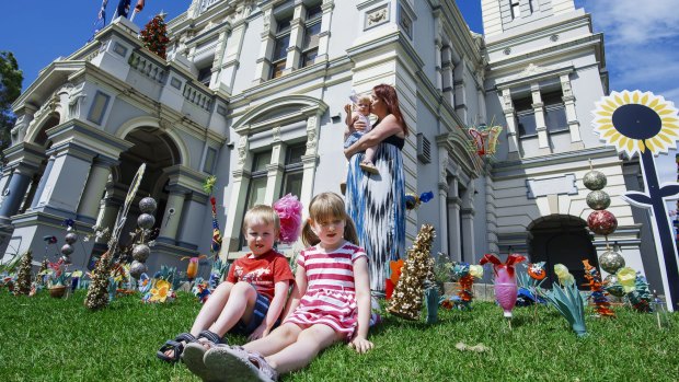 Kate Walsh with her children, Quinn, 5, Aidan, 4, and one-year-old Niamh at Leichhardt Town Hall after school care.