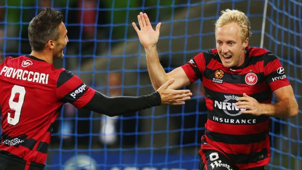 On target: Mitch Nichols of the Wanderers (right) celebrates a goal with Federico Piovaccari.