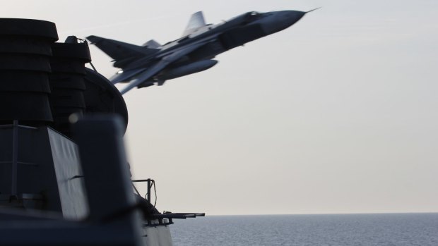 A Russian SU-24 jet makes a close-range, low altitude pass near the USS Donald Cook on Tuesday in the Baltic Sea.